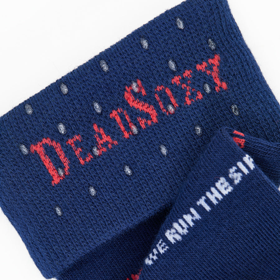 Blue socks with red and white text on a white background that say We Run the Sip