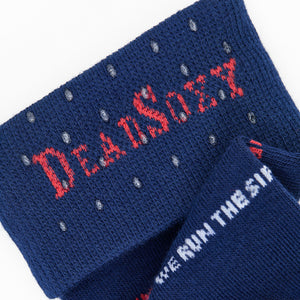 Blue socks with red and white text on a white background that say We Run the Sip