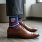 Lifestyle shot of navy striped dress socks worn with dress shoes
