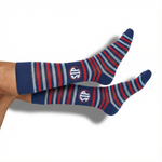 Navy and powder-blue striped dress socks with the SIP on the ankle — side view