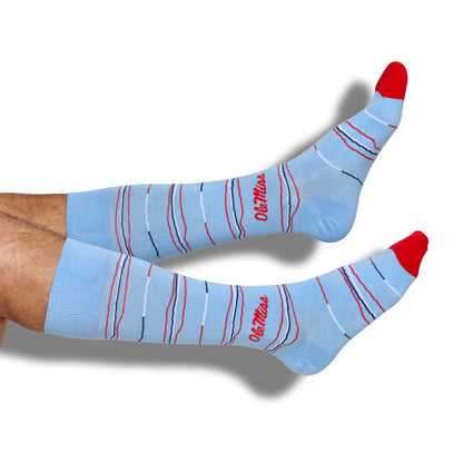 Model wearing Powder Wave Stripe Dress Socks with navy and white wavy stripe pattern.