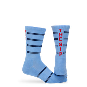 Powder blue athletic casual crew socks with double navy blue stripes and "THE SIP" written up the back of the leg.