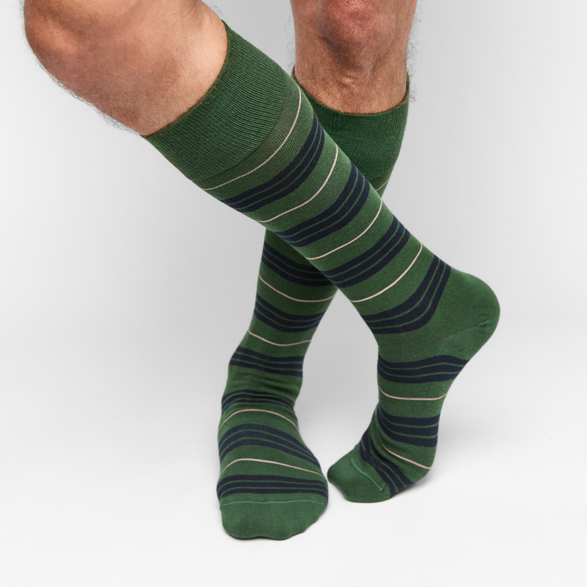 7 pairs of dress socks in various styles laid flat in a circle