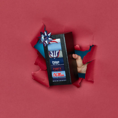 Ole Miss themed 7-pack sock box, featuring a mix of casual and dress socks with university colors and logos holiday version.