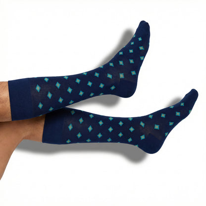 DeadSoxy Parker dress socks in navy with teal and gold diamond pattern worn on foot