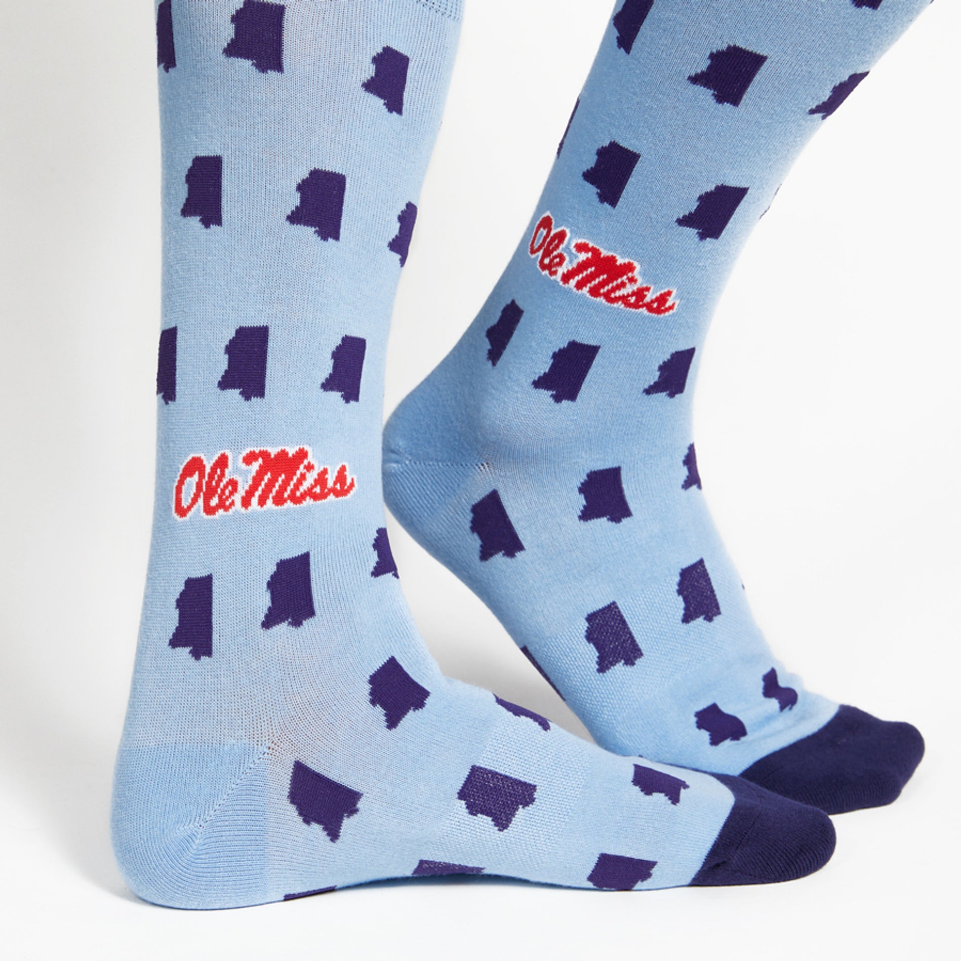 Ole Miss Powder Blue Dress Socks 2-Pack with Mississippi state outlines and Ole Miss logo on model close up.