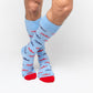 Licensed powder blue dress socks with the Ole Miss script logo in red and navy blue in repeating pattern