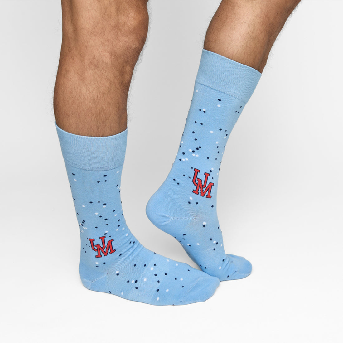 Powder blue dress socks with dot design and UM on the ankle for Ole Miss on male legs