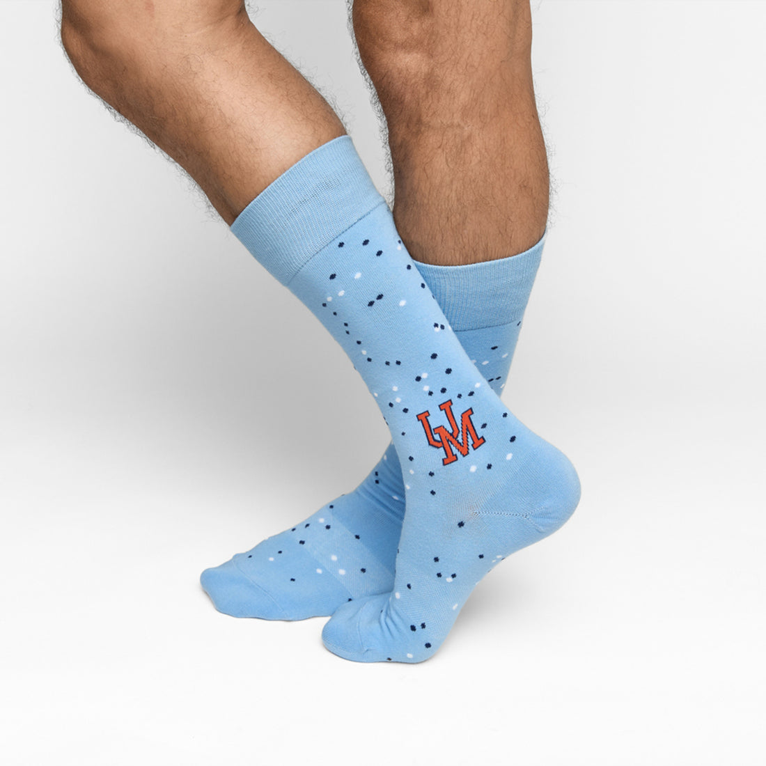 Powder blue dress socks with dot design and UM on the ankle for Ole Miss on male legs crossed