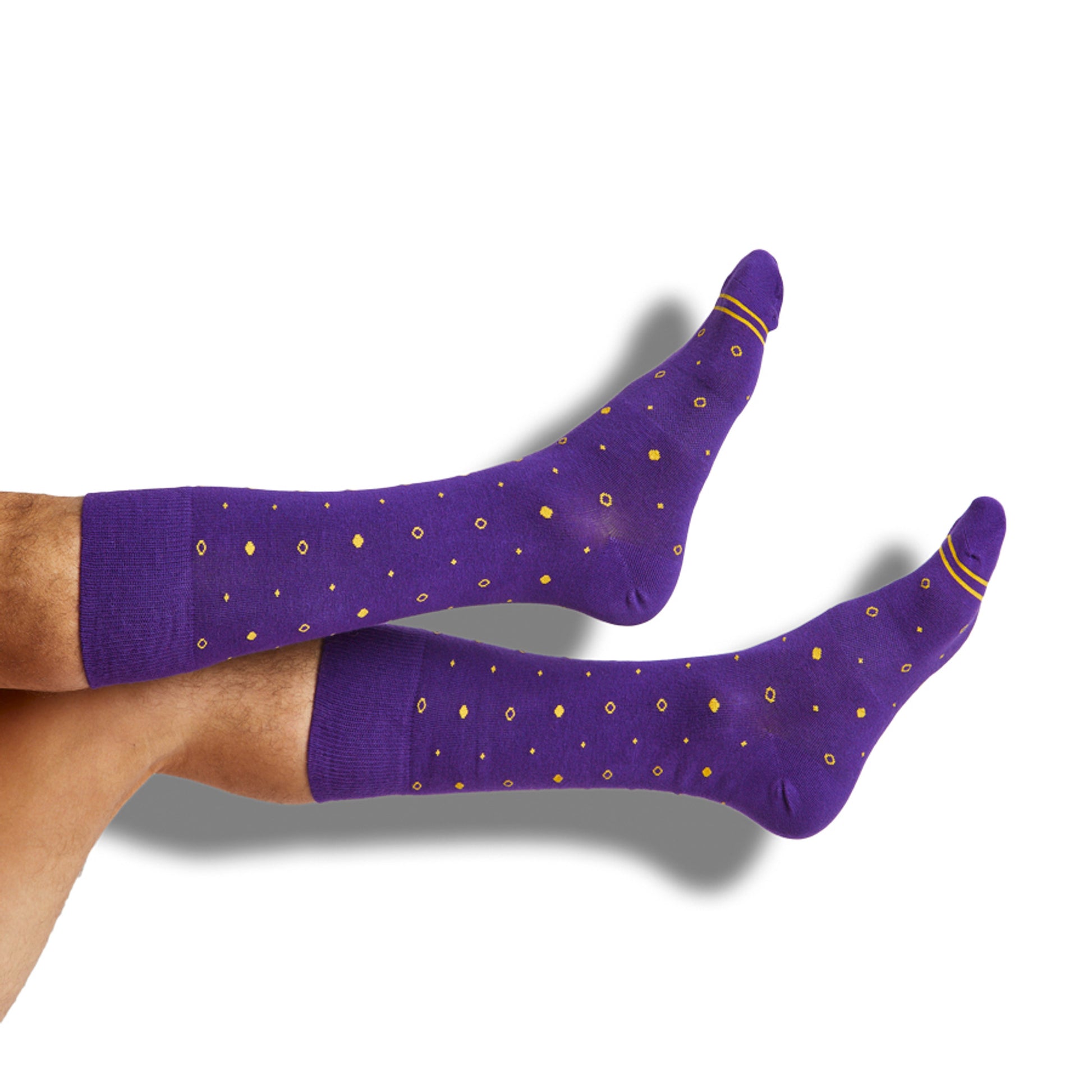 Purple dress socks with gold dots and two gold accent stripes around the toe shown on legs