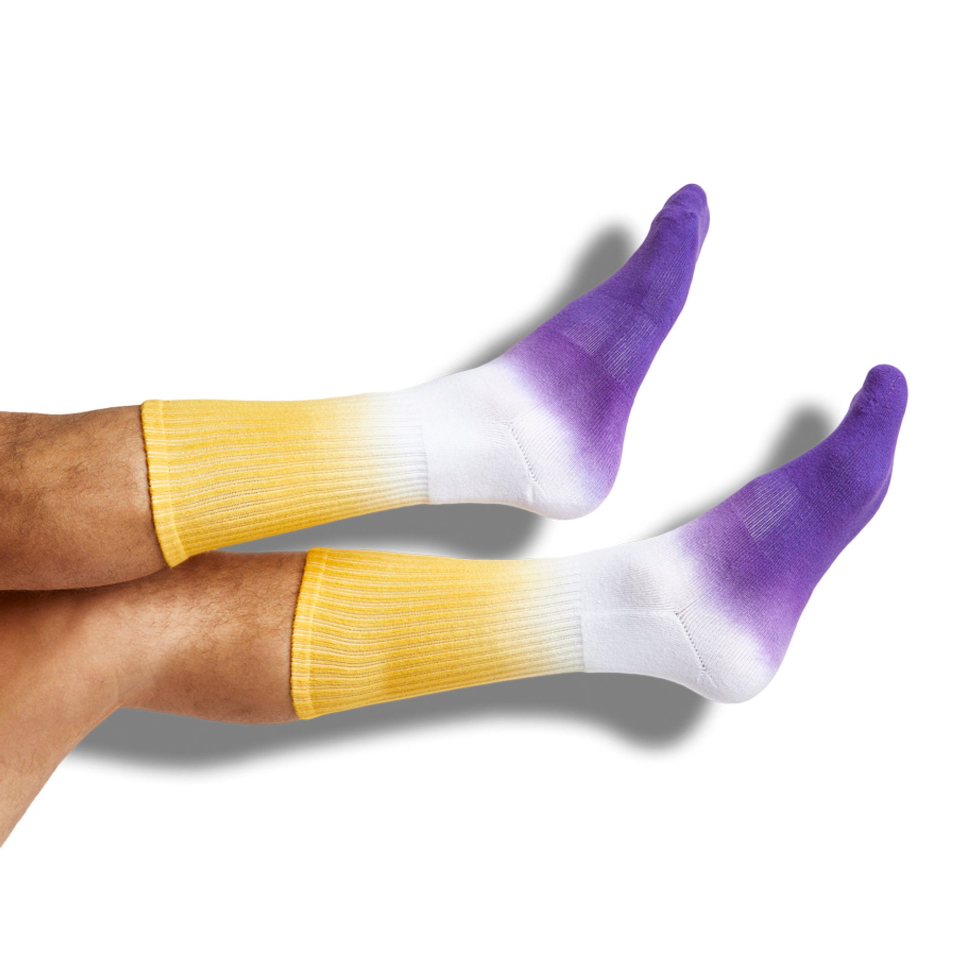 white casual socks with yellow dip on the leg and purple on the foot shown on legs
