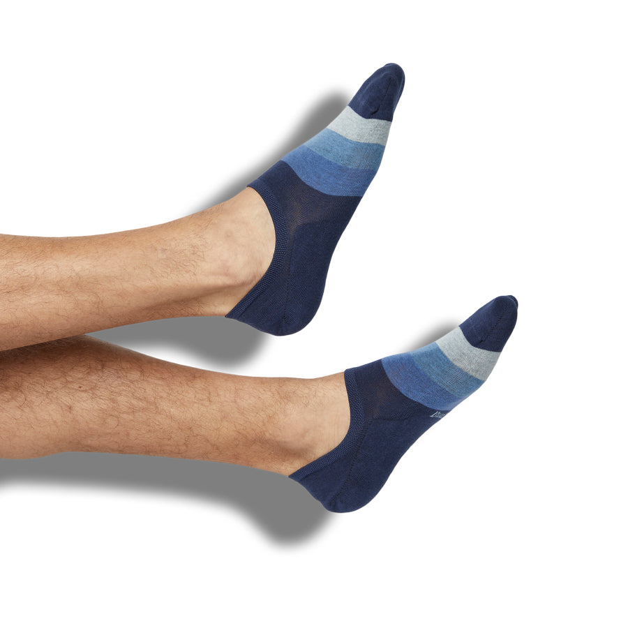 Rich no-show socks styled on a leg form, showing a blue gradient