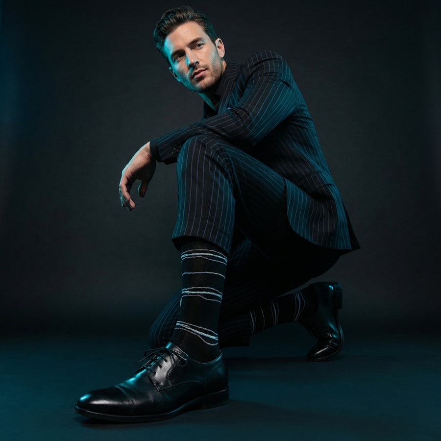 Ross black broken stripe dress socks under neon lighting