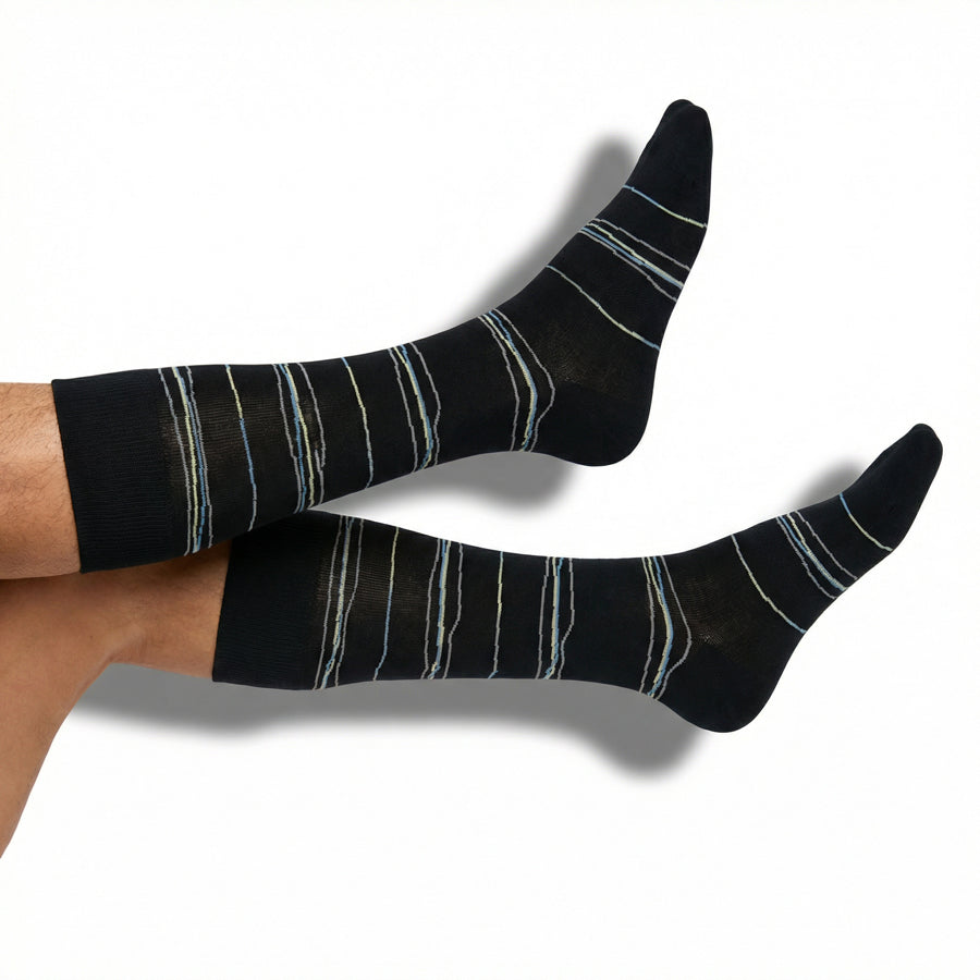 DeadSoxy Ross dress socks in black with subtle broken stripe pattern worn on foot