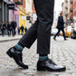 Scott black and teal dress socks styled in urban setting