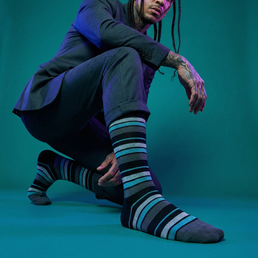 Scott black and teal stripe dress socks under neon lighting