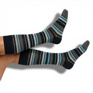 DeadSoxy Scott dress socks in black and teal stripe pattern worn on foot