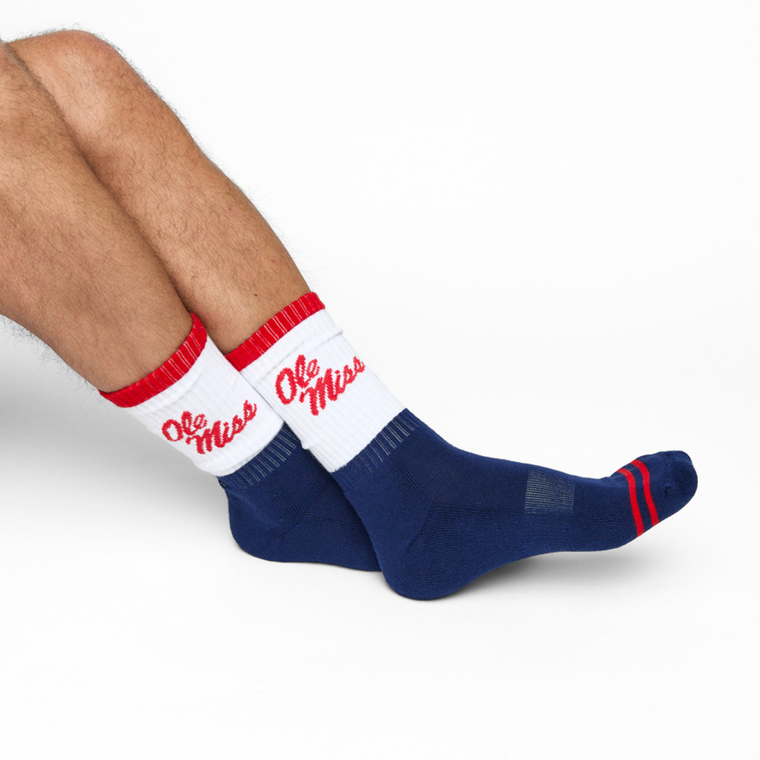 Navy and White 50/50 design with Ole Miss script on the side of the calf shown on male legs sitting crossed