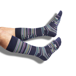 one pair of navy blue dress socks with a patchwork design in multiple accept colors on legs.