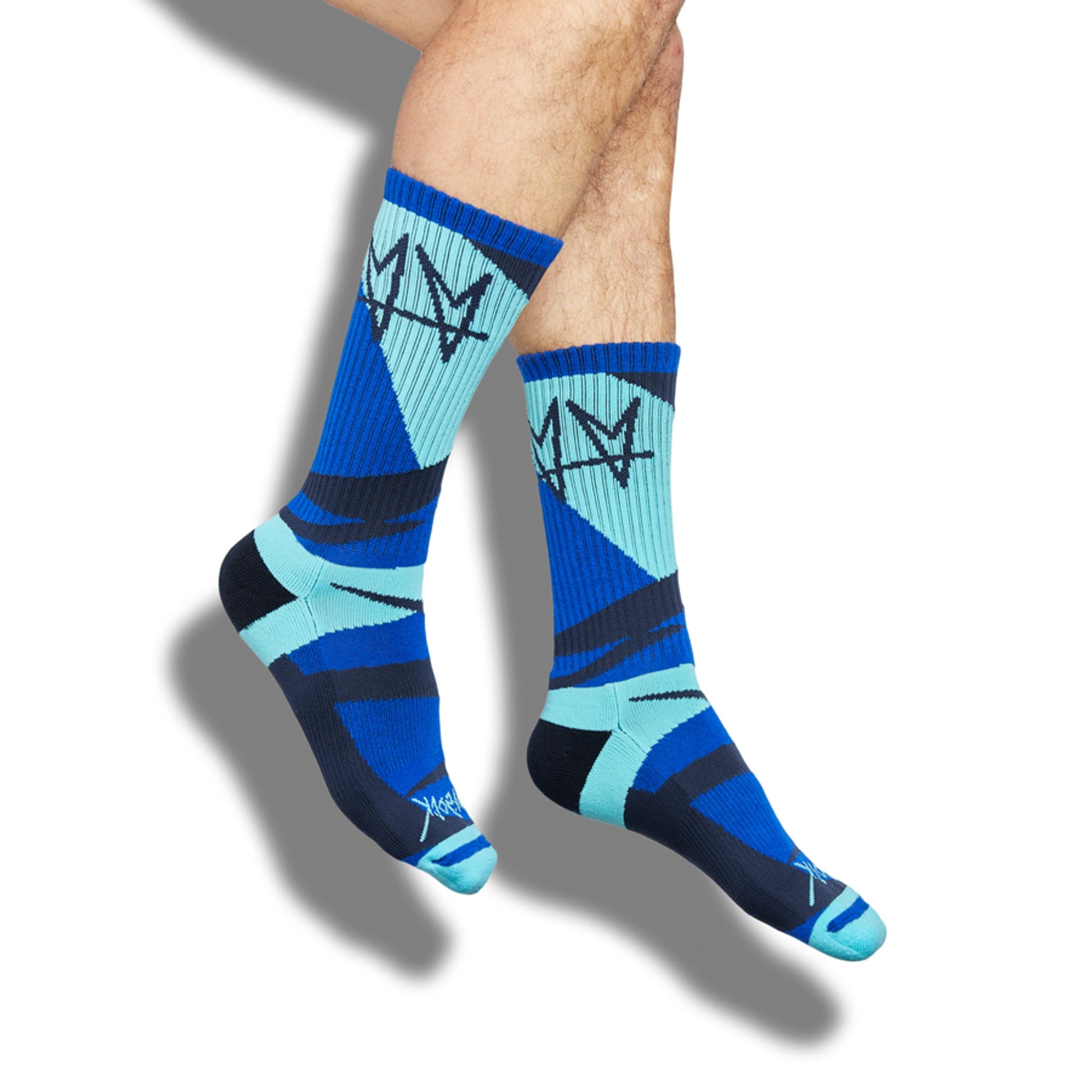 Not.Travis casual collab socks with blue geometric design shown on legs.