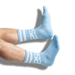 Powder blue casual socks with two retro stripes and the number 25 on the leg