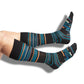 one pair of black dress socks with a patchwork design in multiple accept colors on legs