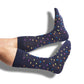 one pair of navy dress socks with multiple color dots design on legs.