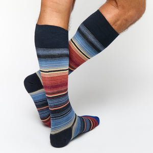 stripe dress socks with red, navy and cream color stripes on legs.
