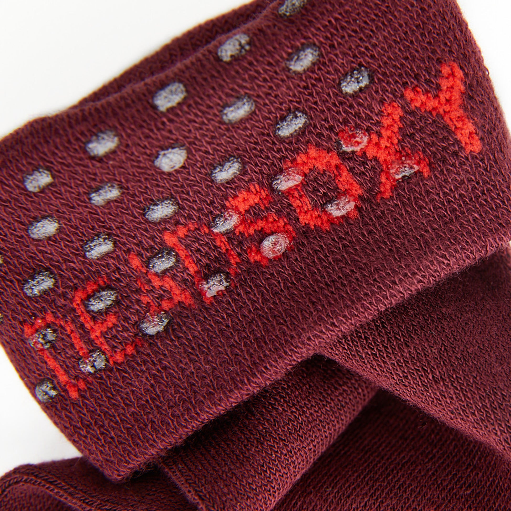 close up view of the knit fabric and TrueStay‚Ñ¢ technology in the welt of the sol dark red dress socks