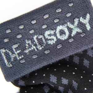 Close up of the DeadSoxy TrueStay‚Ñ¢ tech in the grey welt of dress socks.
