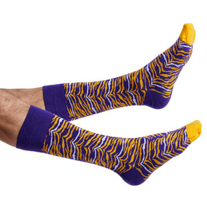 purple and gold tiger stripe dress socks on legs coming into the image from the left