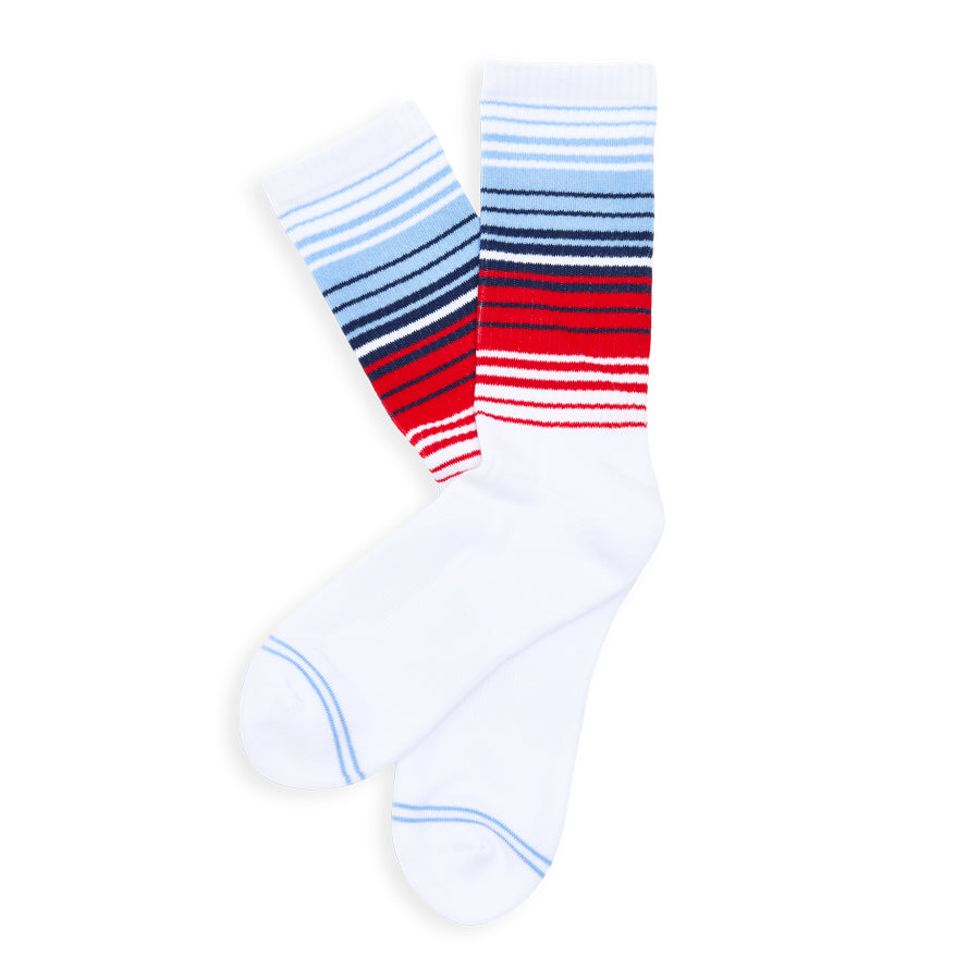 Pair of socks with blue, red, and white horizontal stripes on a white background