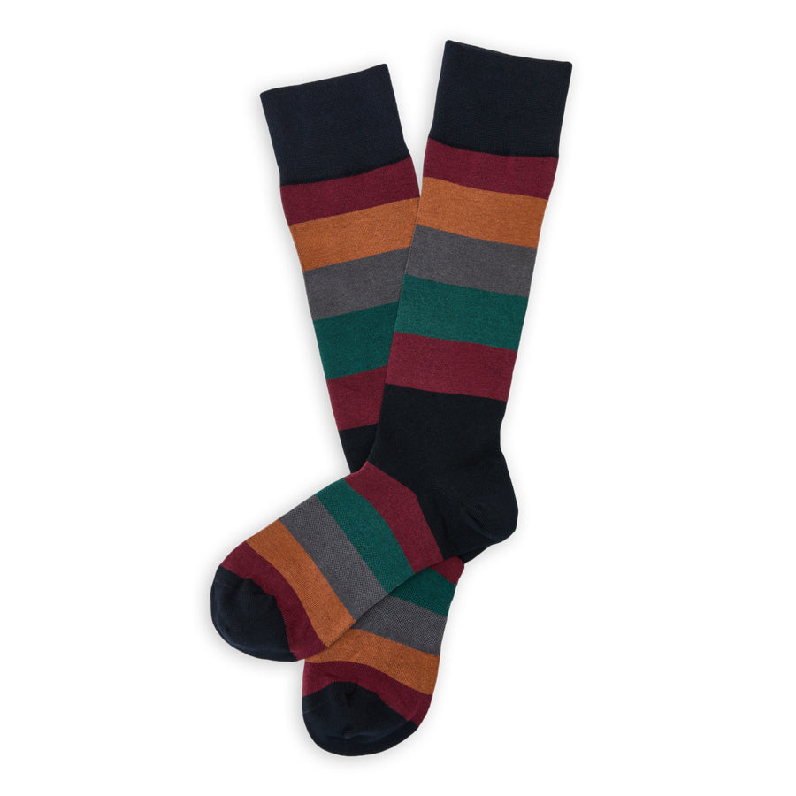 DeadSoxy Wells Cotton Dress Socks flat lay showing wide burgundy, orange, charcoal and green stripes on a dark base