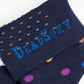 Navy dress socks with medium size dots in purple, orange, yellow, blue and green colors close up of TrueStay‚Ñ¢ in the welt.