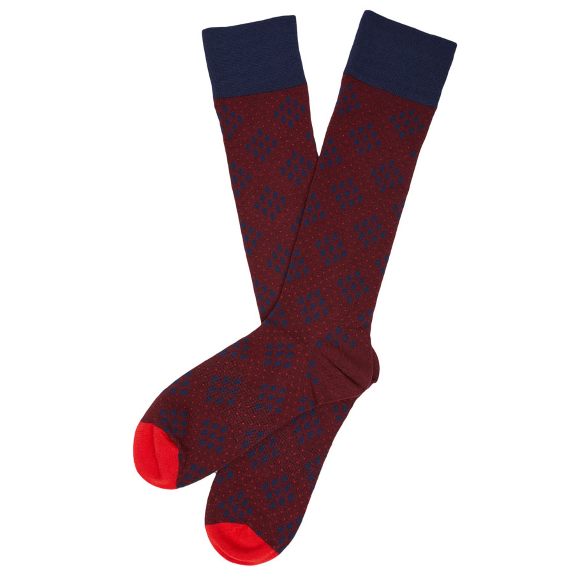 one pair of red elegant dress socks with navy blue diamond dot design laid out flat and crossed at the heel