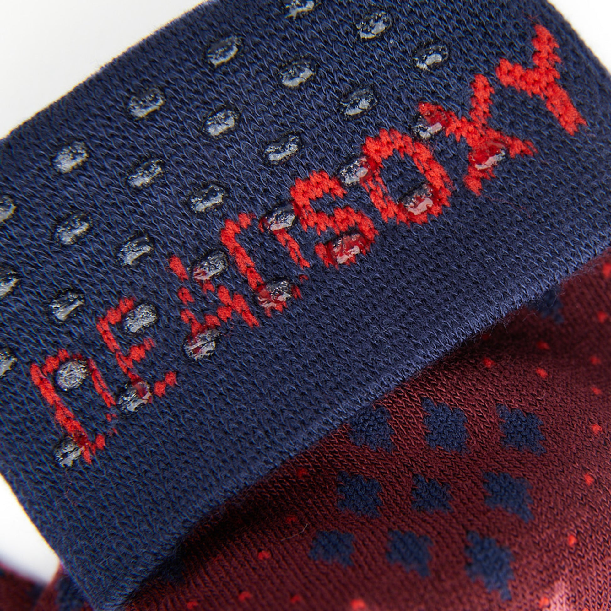Close up of the DeadSoxy TrueStay‚Ñ¢ tech in the navy blue welt of dress socks.