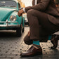 Beckett dress socks worn in an outdoor lifestyle scene with a brown striped pattern visible.