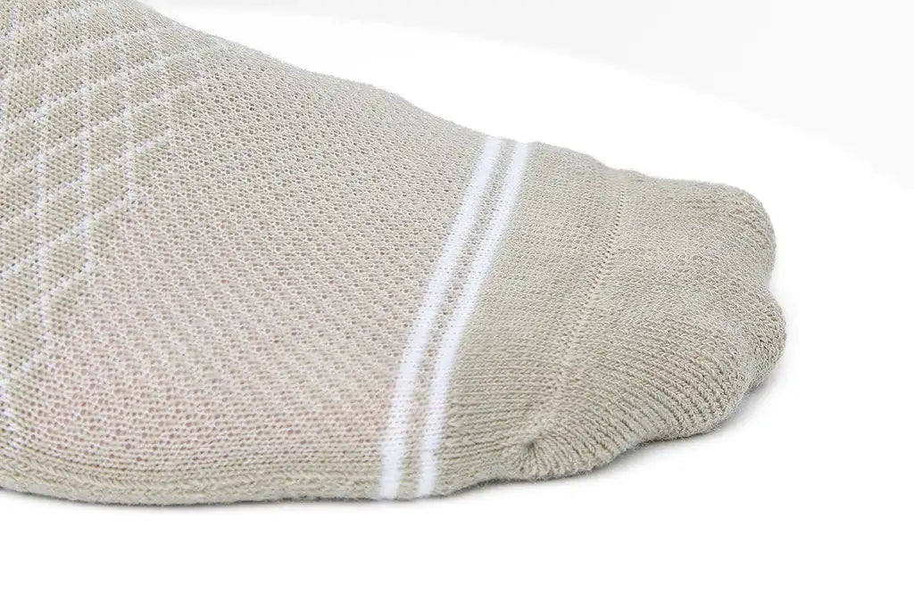 Beige athletic sock with white double stripes at the heel.