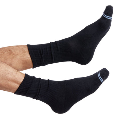 one pair of black casual crew socks with two accents on the toe shown on foot.