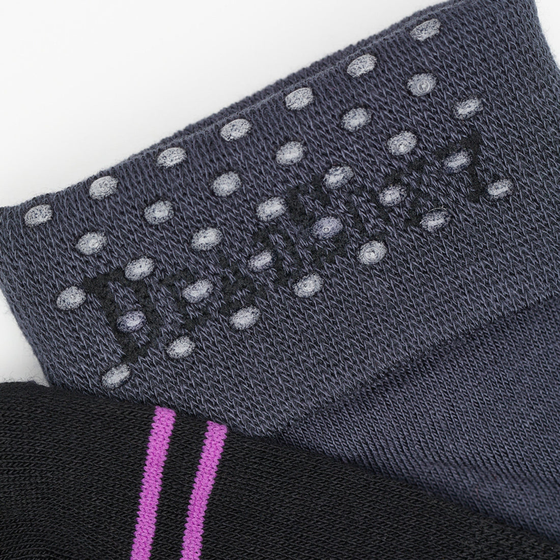 Black and Charcoal dress socks close up image of the TrueStay‚Ñ¢ tech in the welt.