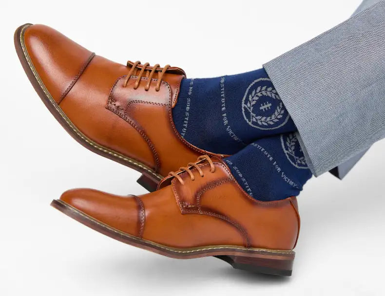 Brown leather derby shoes with tan laces and contrasting stitching.