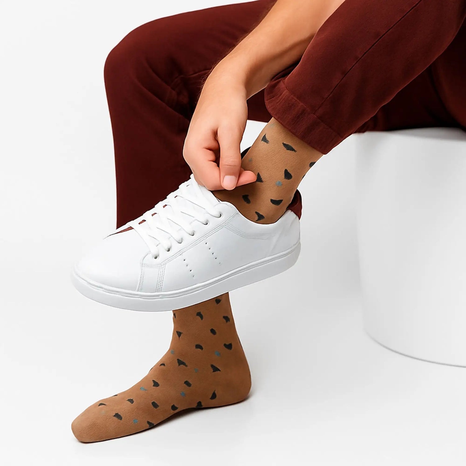 Brown socks with black and gray heart-shaped patterns.