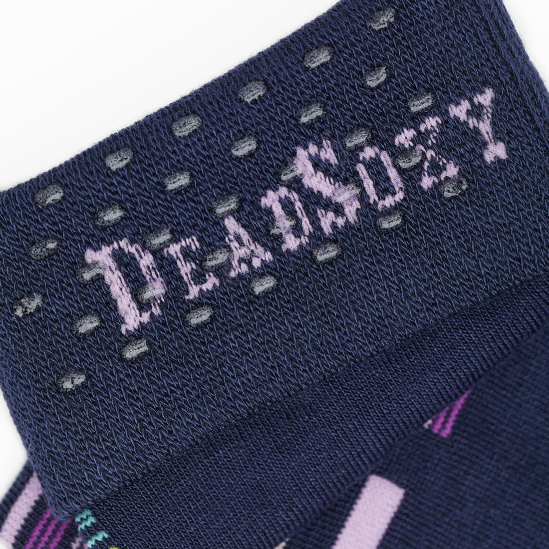 Navy Blue dress socks with green, pink, purple and yellow accents in a patchwork design close up of TrueStay‚Ñ¢ in the welt.
