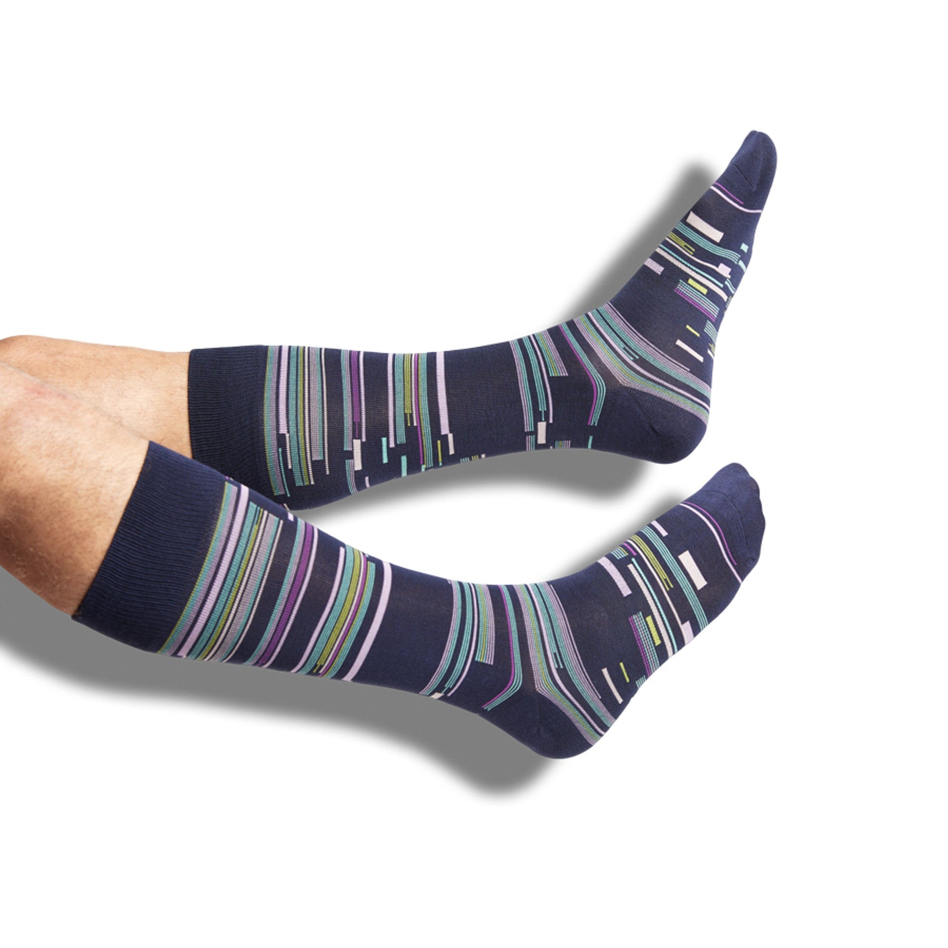 Navy Blue dress socks with green, pink, purple and yellow accents in a patchwork design on legs.