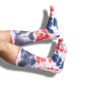 White and Navy and Red Tie-Dye casual crew athletic lounger sock shown on legs coming into the image from the left