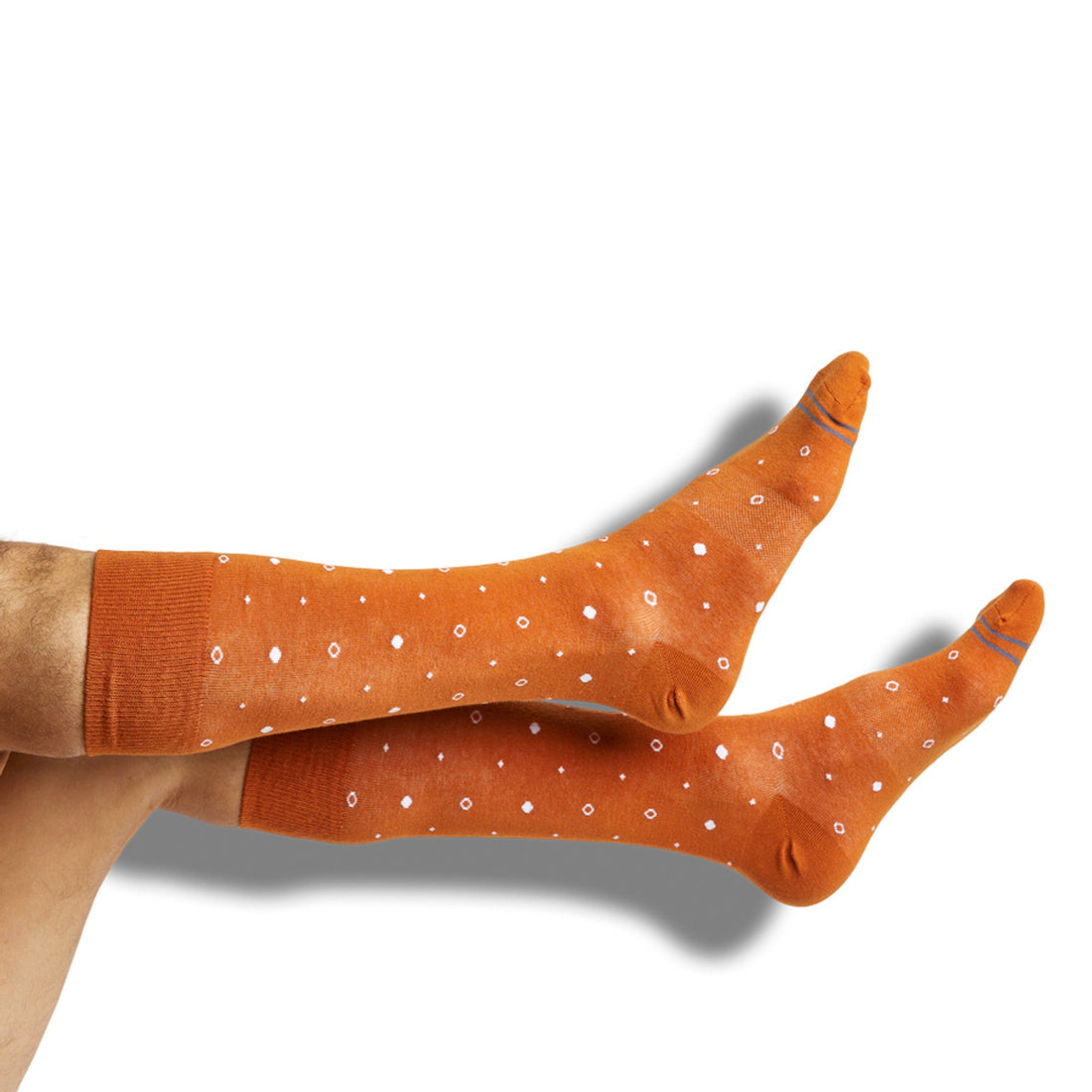 Premium burnt orange dress socks with white dots shown on legs