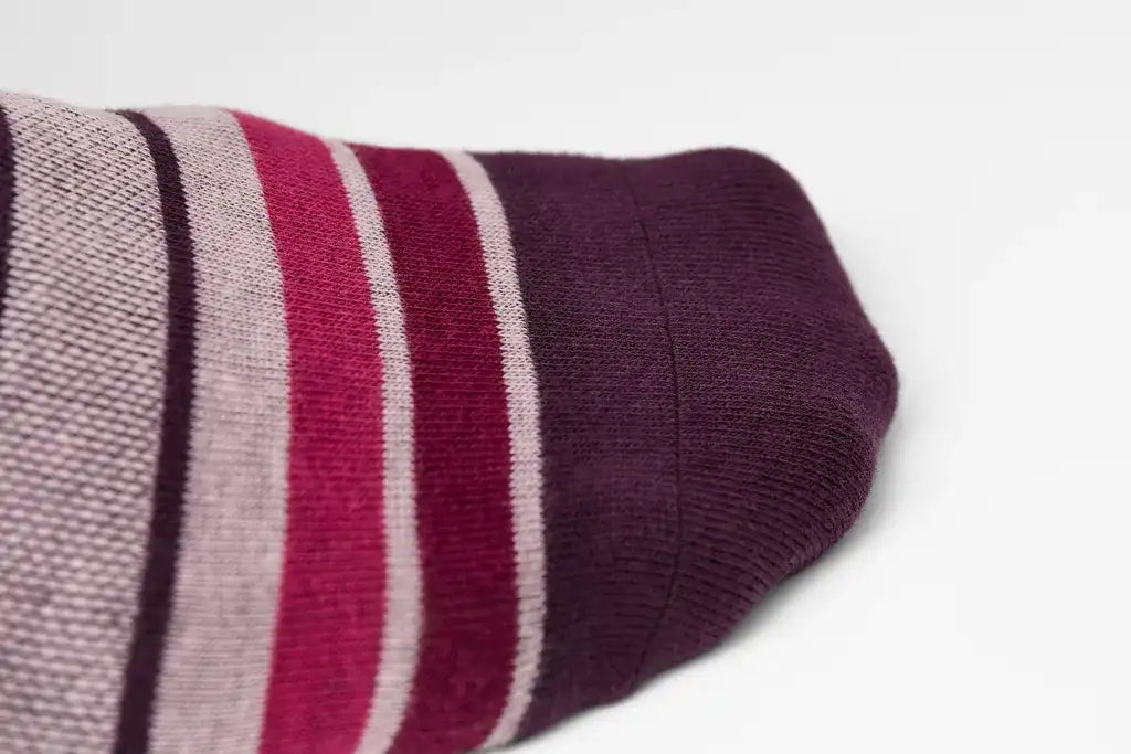 A close-up of a maroon and gray striped sock with a ribbed texture.