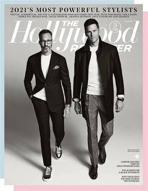 The cover of the hollywood reporter magazine featuring two men in stylish black suits and white shirts.