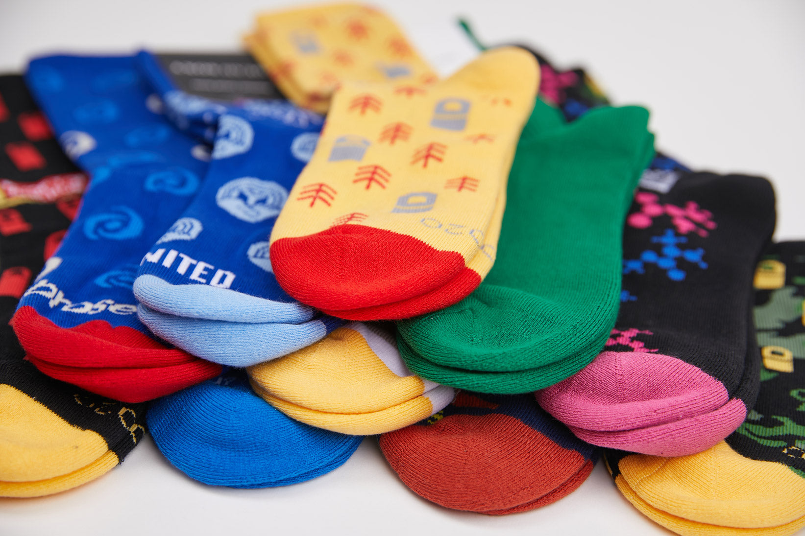 Colorful collection of custom branded socks with company logos and unique designs