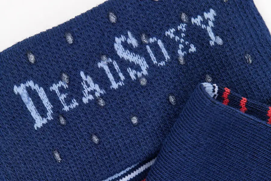 Dark blue knitted sock featuring the word ’deadsoft’ in light blue, accented with small silver beads.